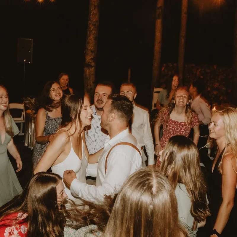 Friends dancing at an outdoor evening celebration
