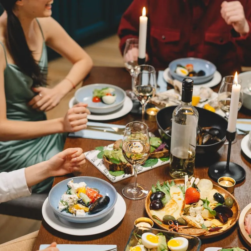 Friends sharing a candle-lit dinner together